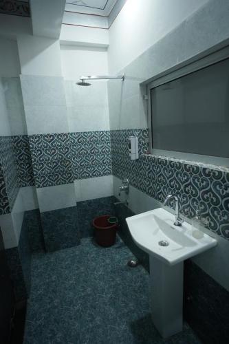 a bathroom with a sink and a mirror at Hostel Funky Bunky in Udaipur
