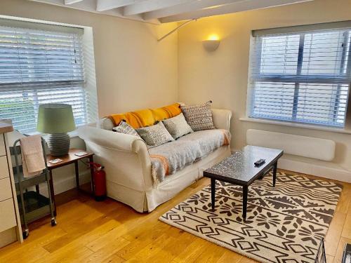 a living room with a couch and a table at Gable End in Arundel