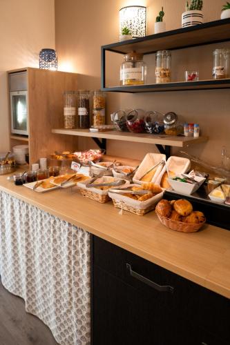 a buffet with bread and pastries on a table at Hôtel Bellevue in Brest