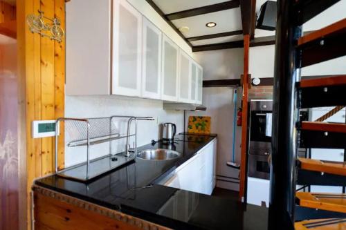a kitchen with a sink and a counter top at Spacious Nature Escape, house for 6 near Amsterdam & Sea in Opmeer