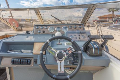 a dashboard of a boat with a steering wheel at Port de Saint-Raphaël in Saint-Raphaël