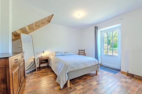 a bedroom with a bed and a desk and a window at Ker Breizh - Saint Pabu - 14 pers in Saint-Pabu