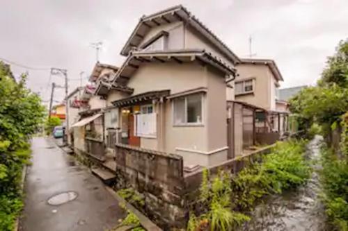 a house sitting on the side of a street at Kanazawa-Hachitabi Sennichi in Kanazawa