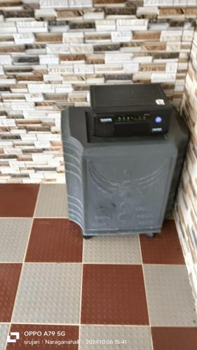 a computer printer sitting in the corner of a room at Giridhama homestay in Chikmagalūr