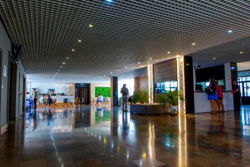 a lobby with people walking around in a building at Cross Resort Hotel in Yerevan