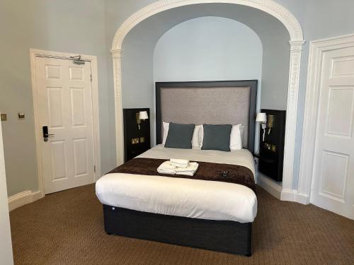 a bedroom with a large bed in a room at Arran House Hotel in London