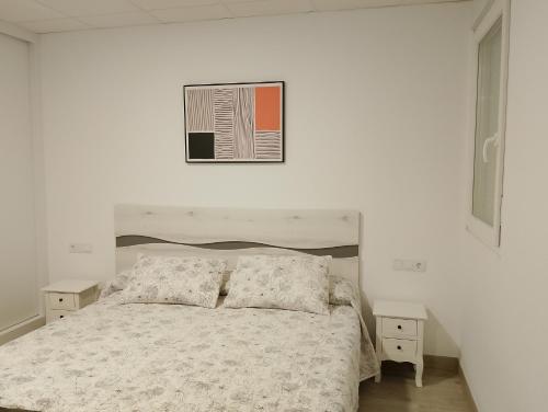 Cama o camas de una habitación en Apartamentos NEMIÑA