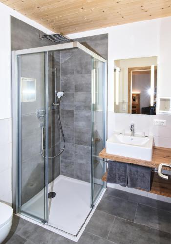 a bathroom with a shower and a sink at Pension Alpenfeeling in Pfronten