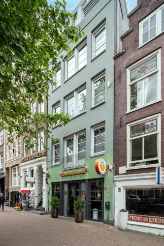 a row of buildings on a city street at Tourist Inn Hotel Amsterdam in Amsterdam