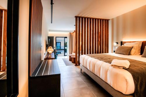 a hotel room with a bed and a balcony at Saladar Suites Boutique in Morro del Jable