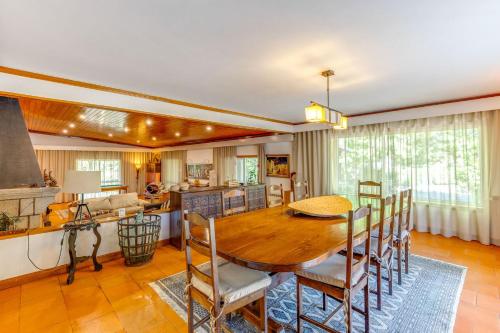 a kitchen and dining room with a wooden table and chairs at Quinta de Santa Luzia in Santo Tirso