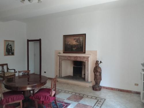 a living room with a table and a fireplace at Villa Gildanna2 in Orio Litta