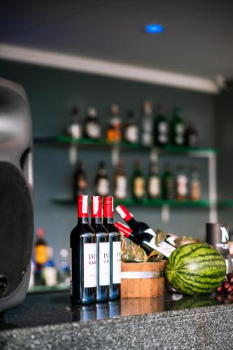 a counter with bottles of wine and a basket of food at Kana Hotel Phuket普吉岛卡娜酒店 in Rawai Beach