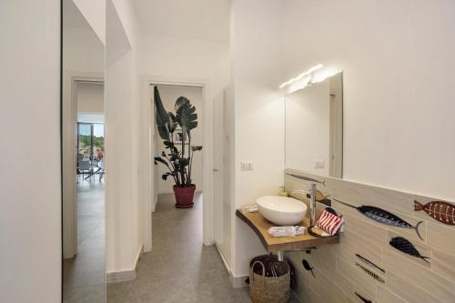 a bathroom with a sink and a mirror at Luxury Villa La Balena Blu in Massa Lubrense