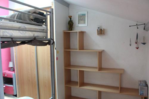 a bedroom with a bunk bed with wooden shelves at Pavillon dans résidence avec piscine au cœur d'Argeles sur mer- 6PM120 in Plage dʼArgelès