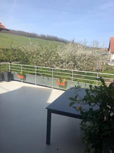 a bench sitting on the balcony of a house at Gîte Binnert Bader in Nothalten