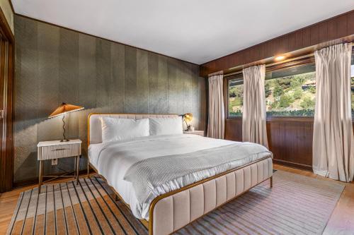 a bedroom with a large bed and a window at Beverly Tree House in Los Angeles