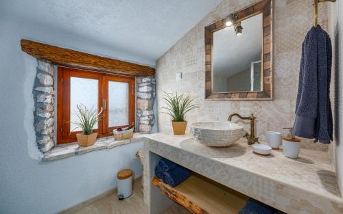 a bathroom with a sink and a mirror at Rustic stone holiday house with pool in Marčana