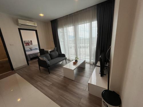 a living room with a couch and a chair at The Prio Condo Chiang Mai in Chiang Mai