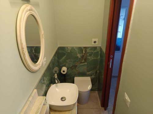 a bathroom with a white toilet and a mirror at Interamna Dreams in Pignataro Interamna