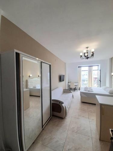 a large bedroom with two beds and a mirror at Schöne Wohnung mitten im Zentrum von Batumi in Batumi