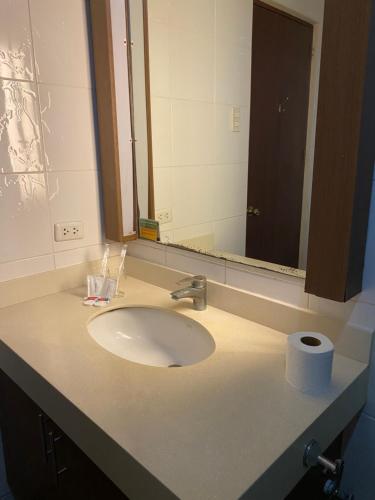 a bathroom sink with a roll of toilet paper on it at Cebu Century Plaza Hotel in Cebu City