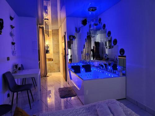 a purple bathroom with a tub and a sink at WARSZAWA CENTRAL HOUSE - Studios in Warsaw with Private Jacuzzi, full access to Sauna, Gym and Billards - Studia z prywatnym Jacuzzi oraz dostępem do sauny, siłowni i bilarda in Warsaw