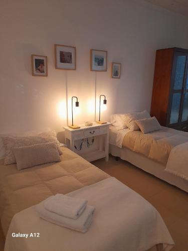 a room with two beds and a table with towels at Acogedor loft a 30 minutos de la playa y montaña in Lebrija