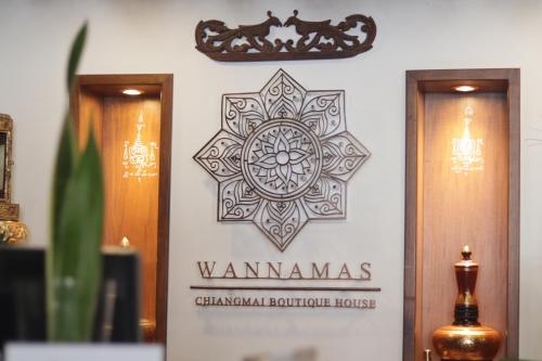 a sign for a chandan boutique house on a wall at Wannamas Chiangmai Boutique House in Chiang Mai