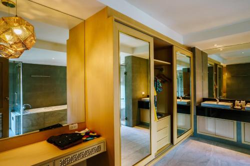 a bathroom with a sink and a mirror at Moon Dragon Hotel in Chiang Mai
