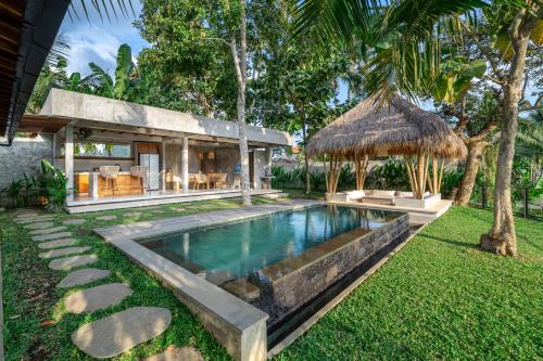 a swimming pool in the backyard of a villa at Sola Villa Ubud in Ubud