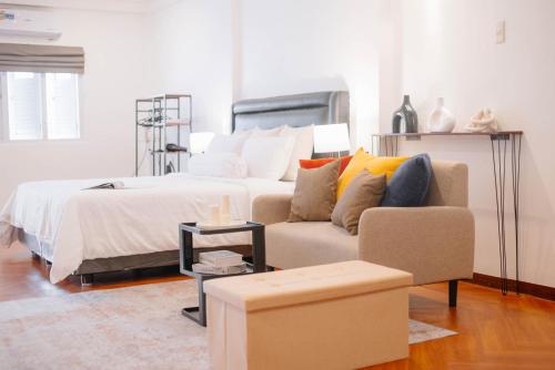 a living room with a bed and a couch at CBD Studio3 next to Sun Plaza Real City Center! in Medan