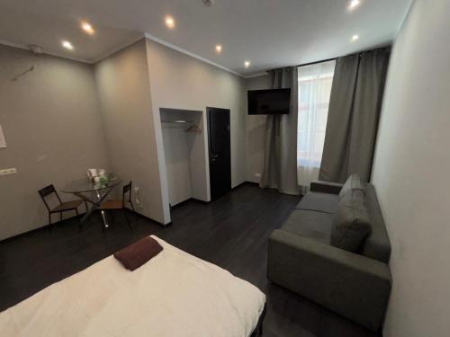 a room with a bed and a couch and a table at ApartHotel Riga in Rīga