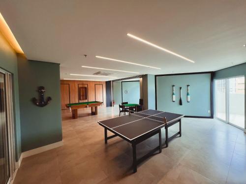 a living room with a ping pong table in it at Aquarius Residence Praia de Iracema in Fortaleza