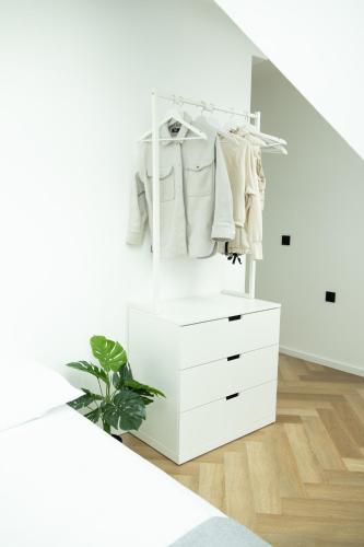 a white closet with a white dresser and white clothes at SI apartments - Smart Inn in Vienna