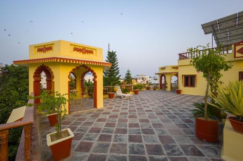 a courtyard of a building with potted plants on it at Alaya Stays 2 BHK With Garden & Outdoor Area - Abhimanyu Mansion Topaz in Udaipur