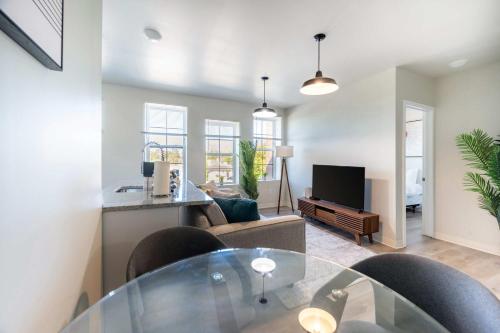 a living room with a glass table and a couch at 2BR Exclusive Retreat Near Henry Ford in Detroit
