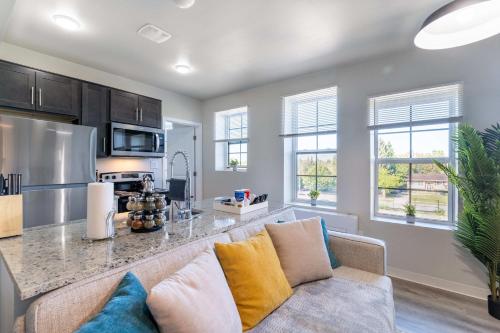 a living room with a couch and a kitchen at 2BR Exclusive Retreat Near Henry Ford in Detroit