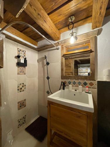 a bathroom with a sink and a shower at Fészek Vendégház in Szandaváralja
