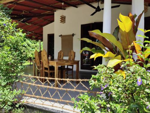 a patio with a table and chairs on a house at Villa Lyvie ayurvedic hotel in Tangalle