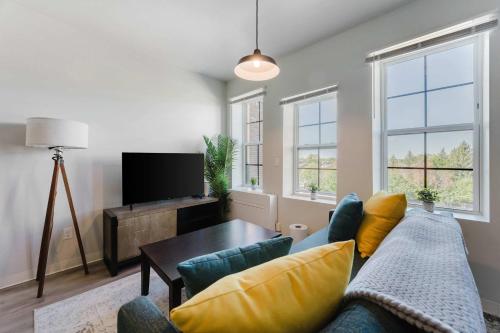 a living room with a couch and a table at 2BR Modern Retreat Near Henry Ford in Detroit