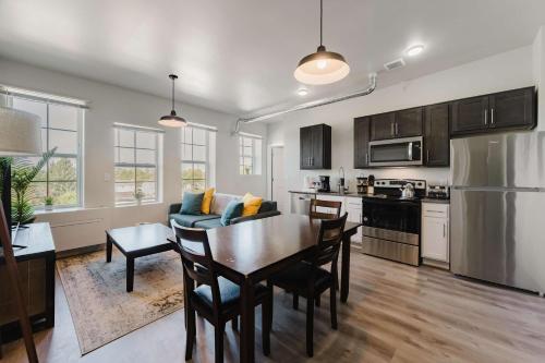a kitchen and dining room with a table and a couch at 2BR Modern Retreat Near Henry Ford in Detroit