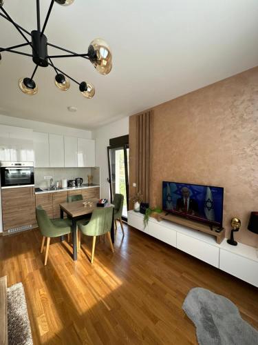 a living room with a dining table and a kitchen at All Seasons Residence in Zlatibor