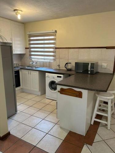 a kitchen with a sink and a dishwasher at 2c - 4 No load shedding 2bed 2bath with garden in Centurion