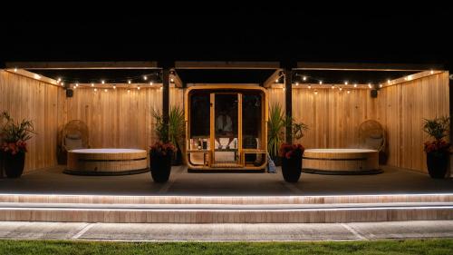 a stage with two tables and lights on it at voco The Club - Dublin Gateway by IHG in Naas