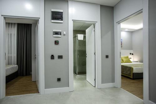 a room with a room with a bed and a mirror at Stile Suite Family Hotel in Antalya
