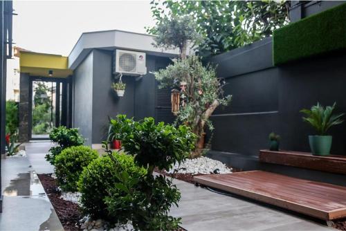 a garden with a wooden bench and plants at Stile Suite Family Hotel in Antalya