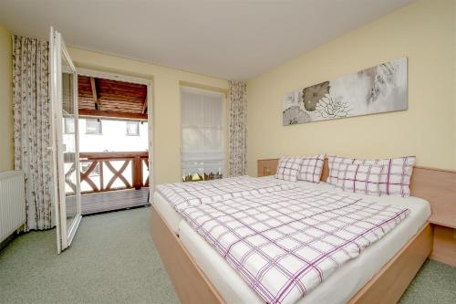 a bedroom with a large bed and a window at Landhaus Brodack in Alt Zauche