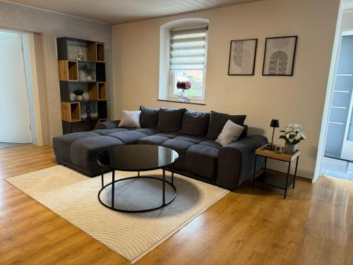 a living room with a couch and a table at FeWo Kümo III an der Regnitz Bischberg's in Bischberg