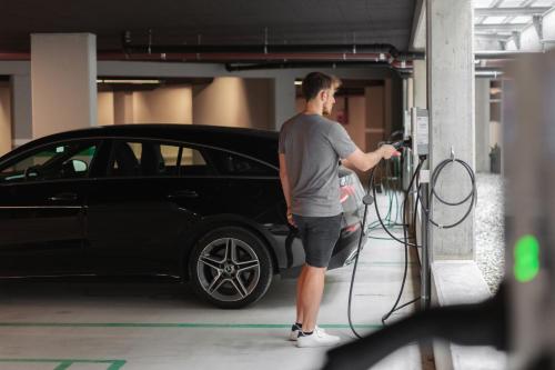a man fueling a car in a garage at AMA Stay in San Vigilio Di Marebbe